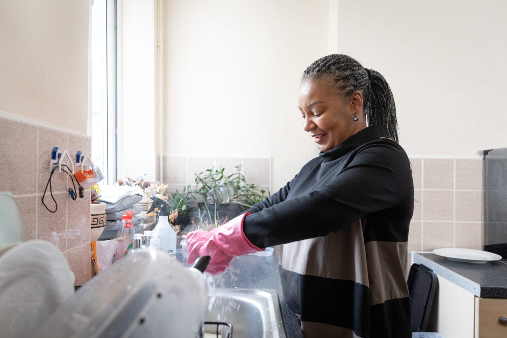 healthy-woman-living-with-hiv-smiling-while-washin-2025-10-15-04-26-07-utc