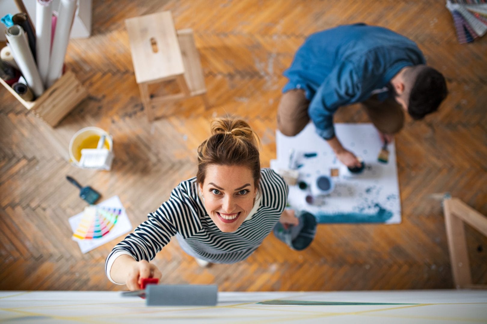 top-view-of-couple-painting-wall-indoors-at-home-2024-10-22-06-04-11-utc